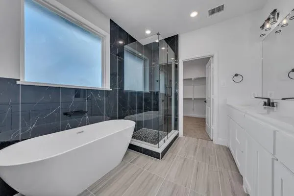 a bathroom with a bathtub and shower