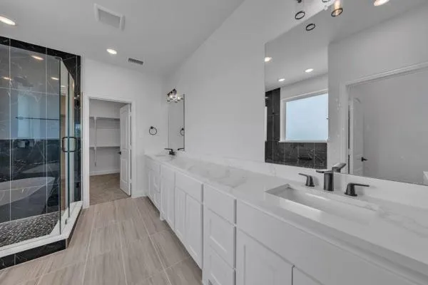 a bathroom with a double vanity sink and a mirror
