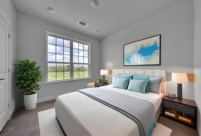 a bedroom with a bed and a potted plant