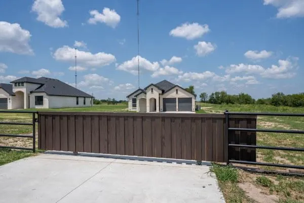 a view of a brick house with a small yard