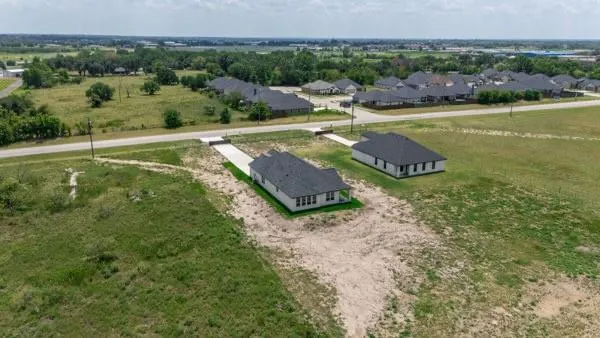 a view of a large garden with a house in the background