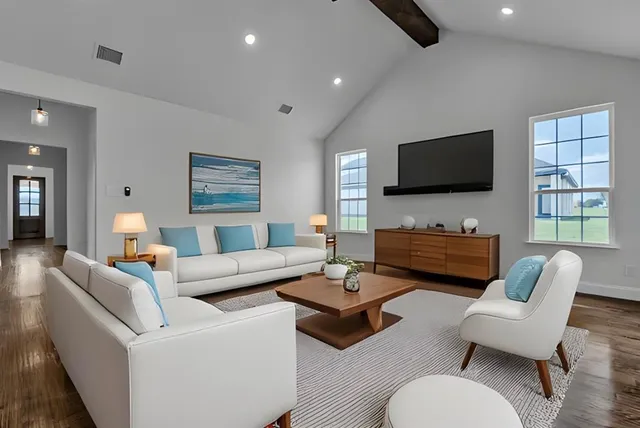 a living room with furniture a flat screen tv and a large window