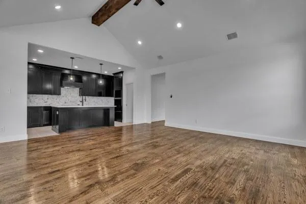 a view of kitchen with refrigerator and microwave