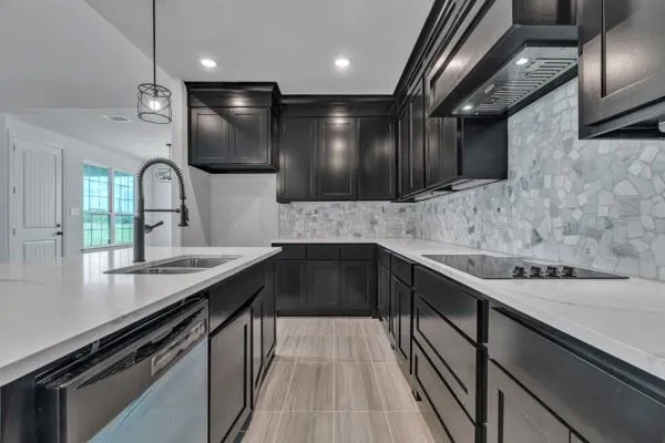 a kitchen with a sink stainless steel appliances and cabinets