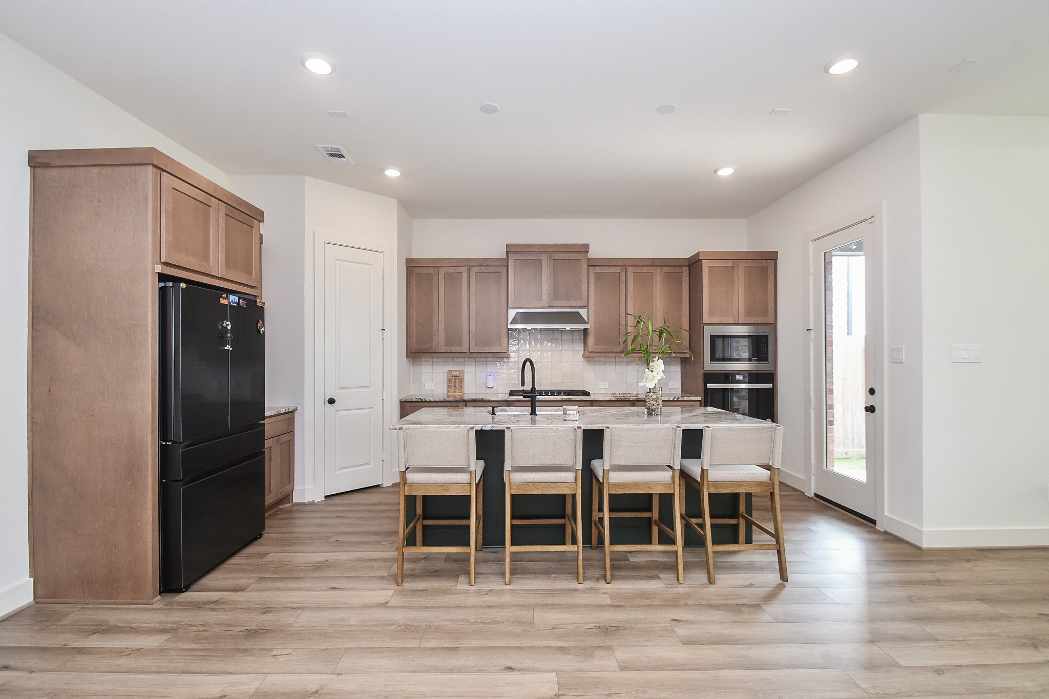 31915 Sky Rdg Lane Fulshear, TX 77441 - Photo 18 of 38 Well-designed kitchen presenting convenience and timeless style with its thoughtfully crafted cabinetry, stainless steel appliances, and generous room space.
