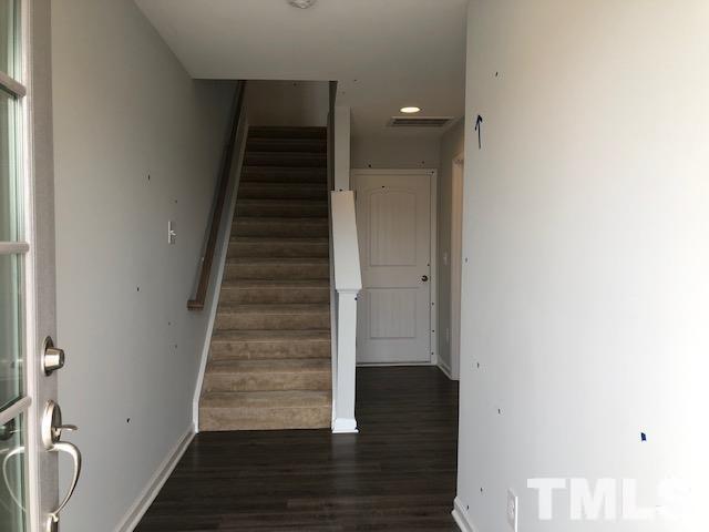 307 Devon Clfs Drive Wake Forest, NC 27587 - Photo 2 of 13 a view of hallway with stairs and wooden floor