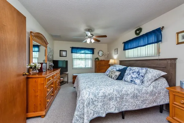 a bedroom with a large bed and a dresser