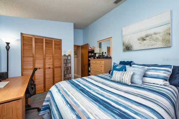 a bedroom with furniture and large window