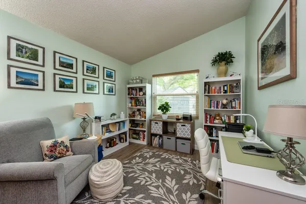a living room with furniture and a bookshelf