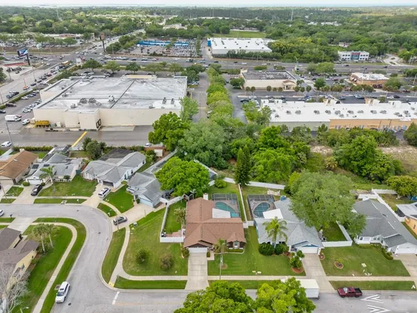 an aerial view of residential houses with outdoor space and parking
