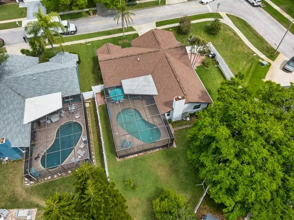 an aerial view of residential house with outdoor space and swimming pool