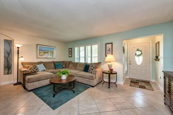 a living room with furniture potted plant and a window