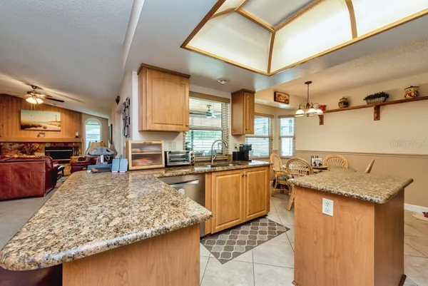 a kitchen with stainless steel appliances granite countertop sink stove and refrigerator