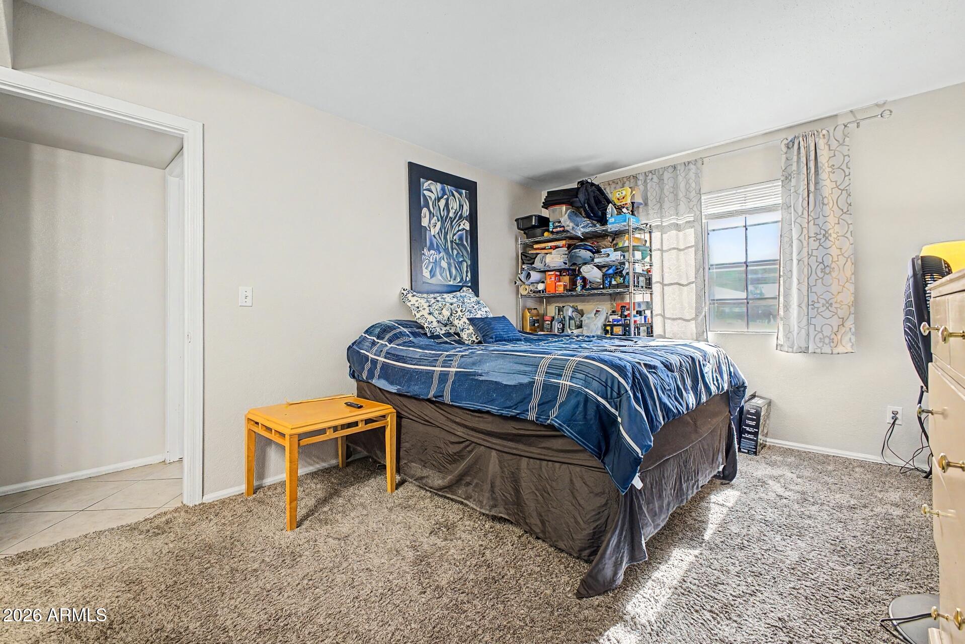 533 West Guadalupe Road, Unit 1104 Mesa, AZ 85210 - Photo 6 of 20 a bedroom with a bed and a book shelf