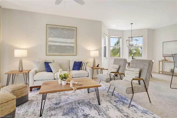 a living room with furniture and a chandelier