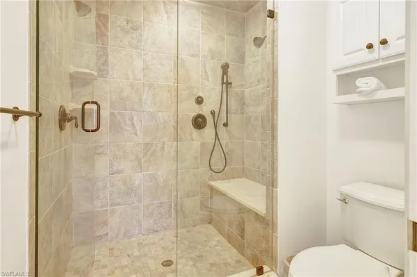 a bathroom with a shower and toilet