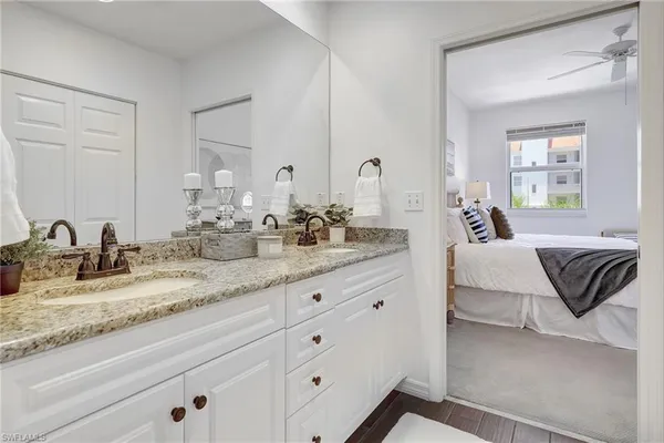 a spacious bathroom with double vanity and a mirror