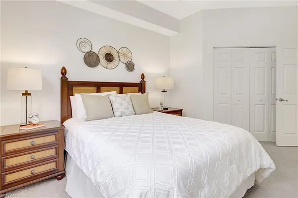 a bedroom with a bed and painting on the wall