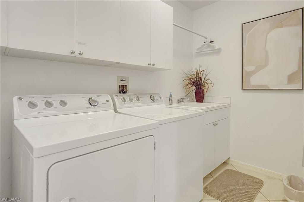 470 Launch Circle, Unit V405 Naples, FL 34108 - Photo 28 of 41 a utility room with dryer and washer