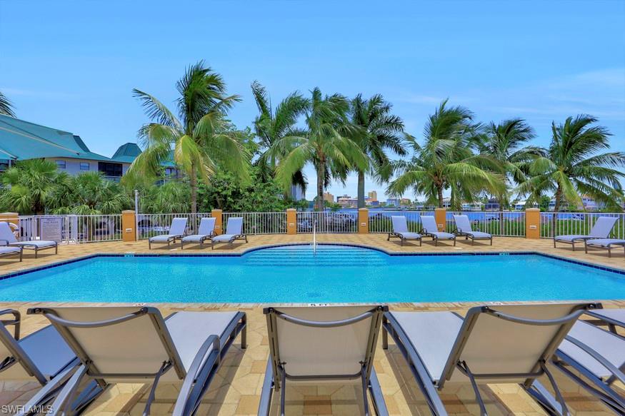 470 Launch Circle, Unit V405 Naples, FL 34108 - Photo 33 of 41 a view of a swimming pool and lounge chair