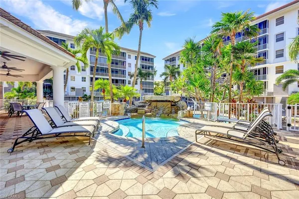 a building outdoor space with patio furniture and potted plants
