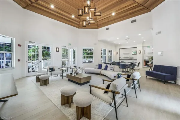 a living room with furniture and a chandelier