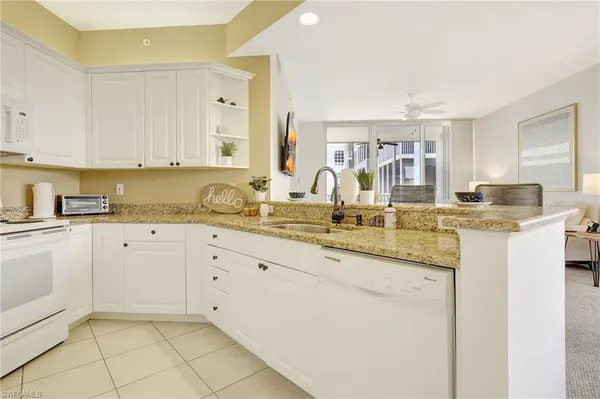 a kitchen with granite countertop a sink and cabinets