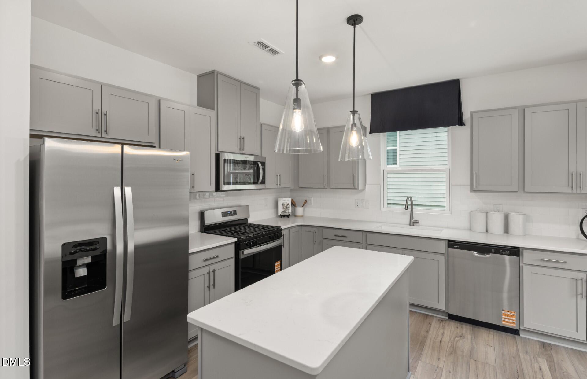 605 Timber Terrace Drive Durham, NC 27704 - Photo 3 of 31 a kitchen with stainless steel appliances a refrigerator sink and microwave