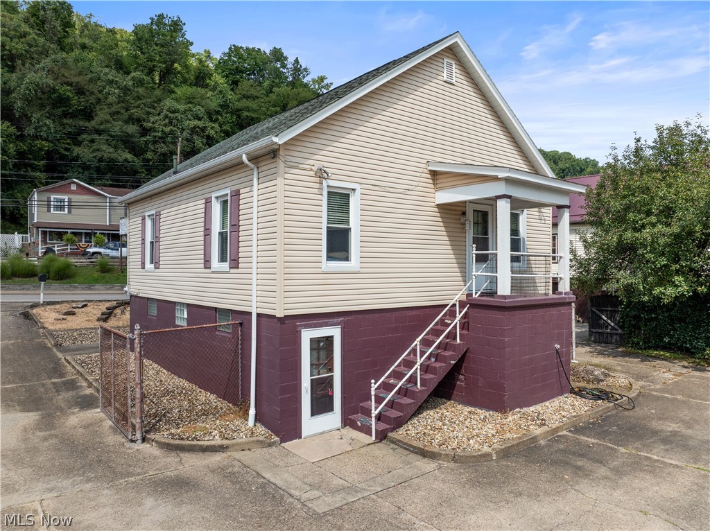 54490 National Road Bridgeport, OH 43912 - Photo 15 of 32 Two-story exterior with light-colored siding and a contrasting base