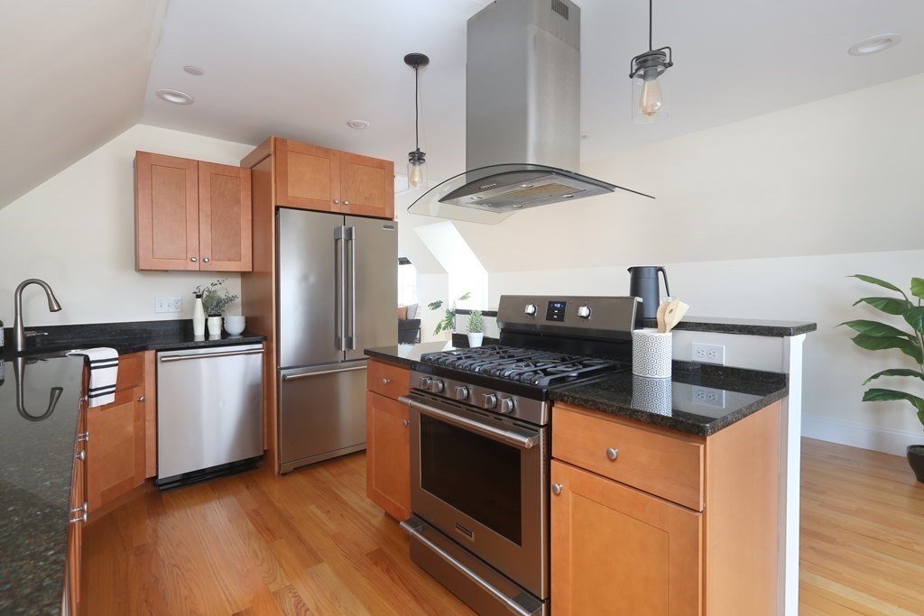 150 Lowell Street, Unit 3 Somerville, MA 02143 - Photo 4 of 12 a kitchen with stainless steel appliances granite countertop a stove a refrigerator and a sink