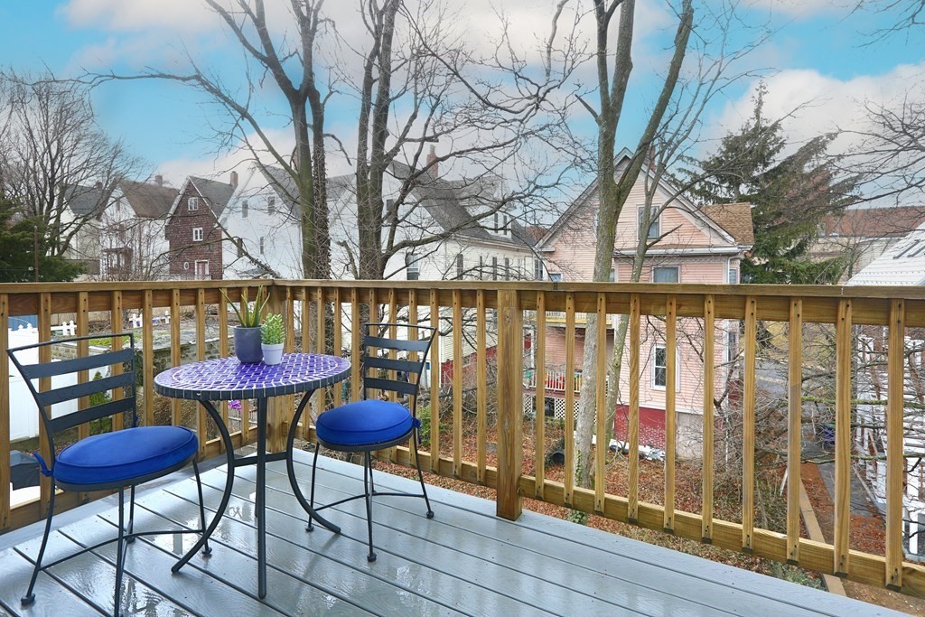 150 Lowell Street, Unit 3 Somerville, MA 02143 - Photo 10 of 12 a view of a chairs and table on the deck