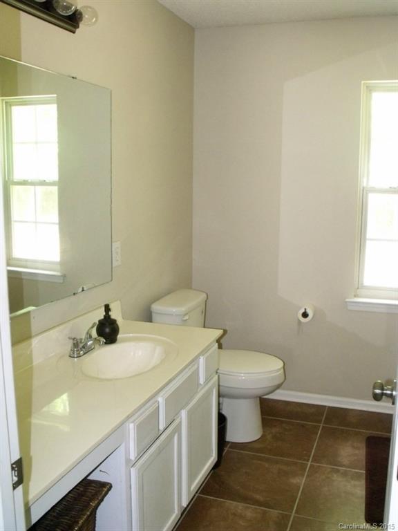 15210 Tracy Beth Road Huntersville, NC 28078 - Photo 14 of 24 a bathroom with a sink toilet and a window