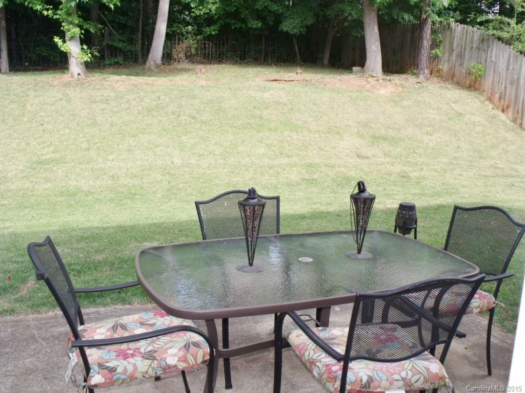 15210 Tracy Beth Road Huntersville, NC 28078 - Photo 19 of 24 a view of balcony with table and chairs potted plants and barbeque oven