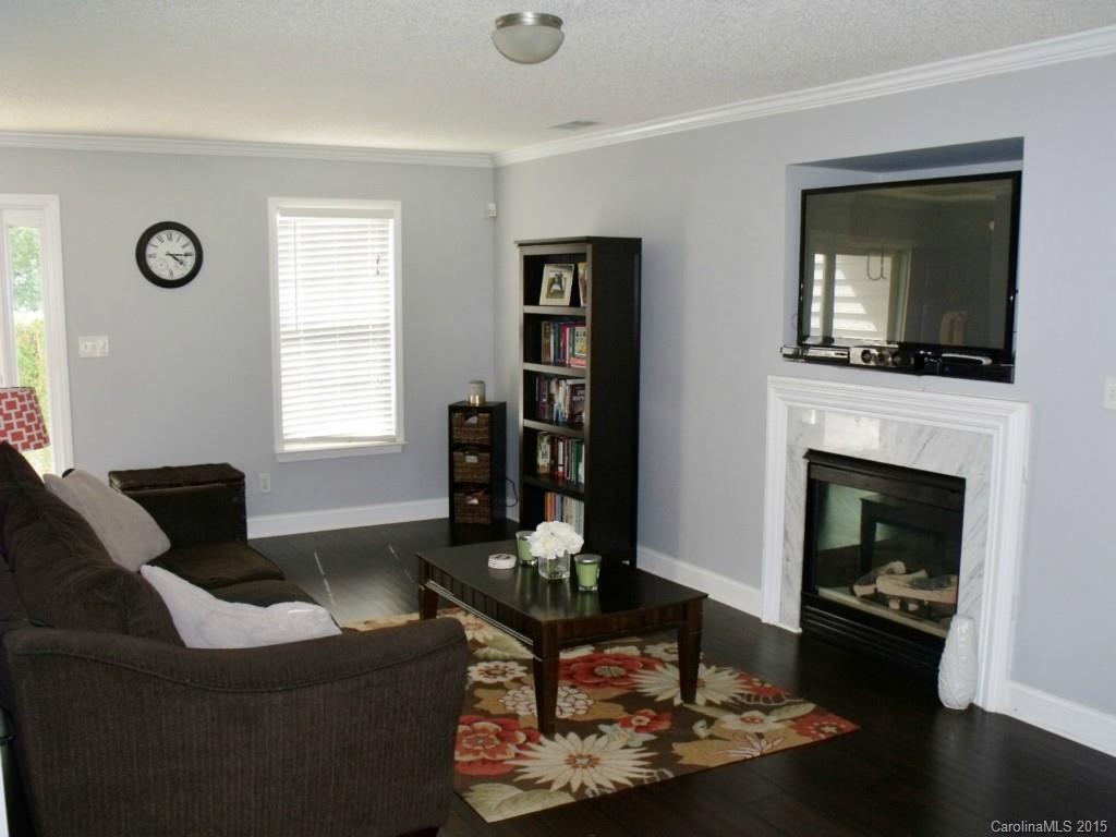 15210 Tracy Beth Road Huntersville, NC 28078 - Photo 4 of 24 a living room with furniture and a fireplace