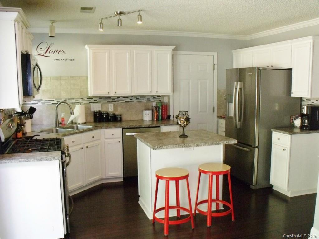 15210 Tracy Beth Road Huntersville, NC 28078 - Photo 9 of 24 a kitchen with a sink refrigerator and cabinets