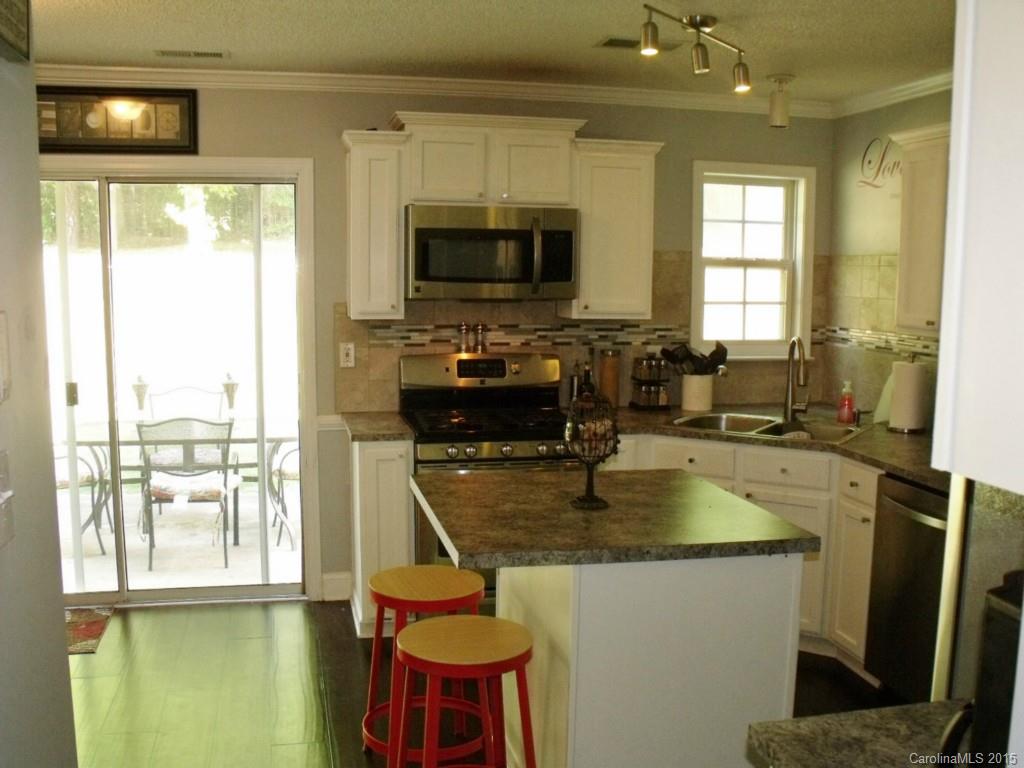 15210 Tracy Beth Road Huntersville, NC 28078 - Photo 10 of 24 a kitchen with sink a window and chairs