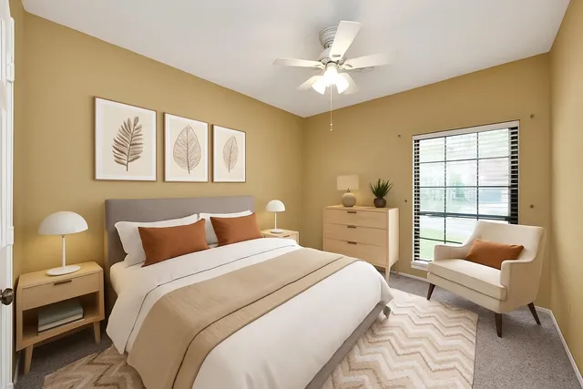 an empty room with a ceiling fan and a window
