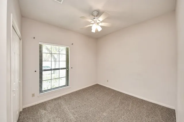 a view of a livingroom with a chandelier fan