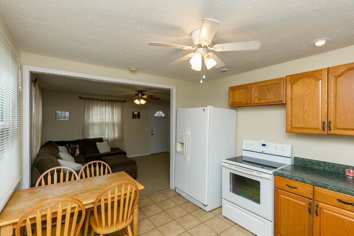 304 Randy Road Madison, TN 37115 - Photo 13 of 34 a kitchen with stainless steel appliances kitchen island granite countertop a table and a refrigerator