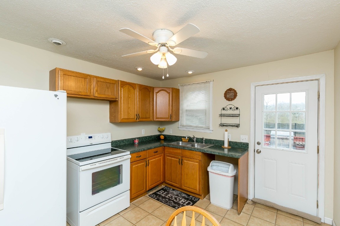 304 Randy Road Madison, TN 37115 - Photo 16 of 34 a kitchen with a stove a sink and a refrigerator
