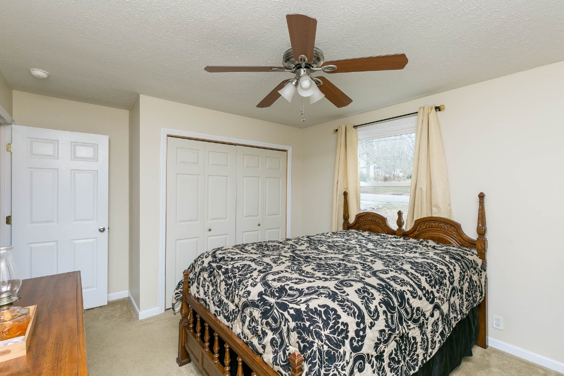 304 Randy Road Madison, TN 37115 - Photo 18 of 34 a bedroom with a bed and a chandelier