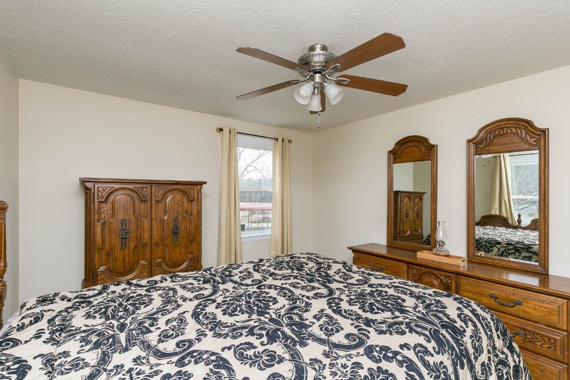 304 Randy Road Madison, TN 37115 - Photo 20 of 34 a bedroom with a bed and a chandelier