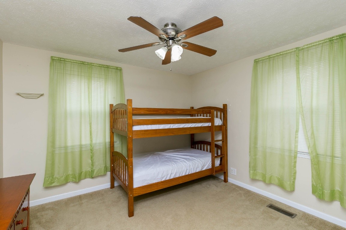 304 Randy Road Madison, TN 37115 - Photo 21 of 34 a bedroom with a bed and a ceiling fan