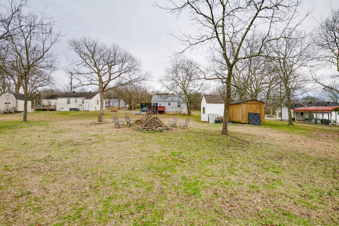 304 Randy Road Madison, TN 37115 - Photo 31 of 34 a view of a yard with brick house and a large tree