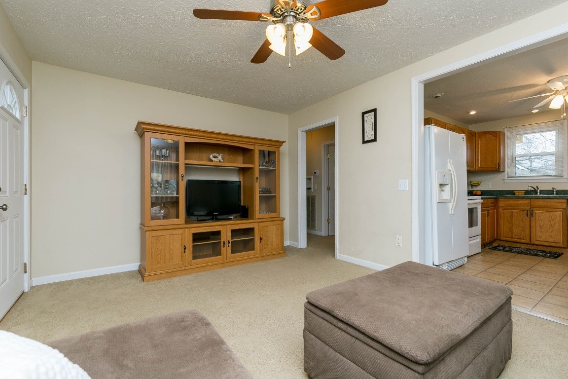 304 Randy Road Madison, TN 37115 - Photo 8 of 34 a living room with stainless steel appliances kitchen island granite countertop furniture and a view of living room
