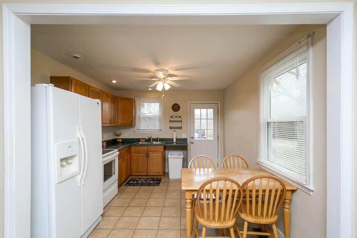 304 Randy Road Madison, TN 37115 - Photo 9 of 34 a kitchen with granite countertop a stove a refrigerator and wooden floor