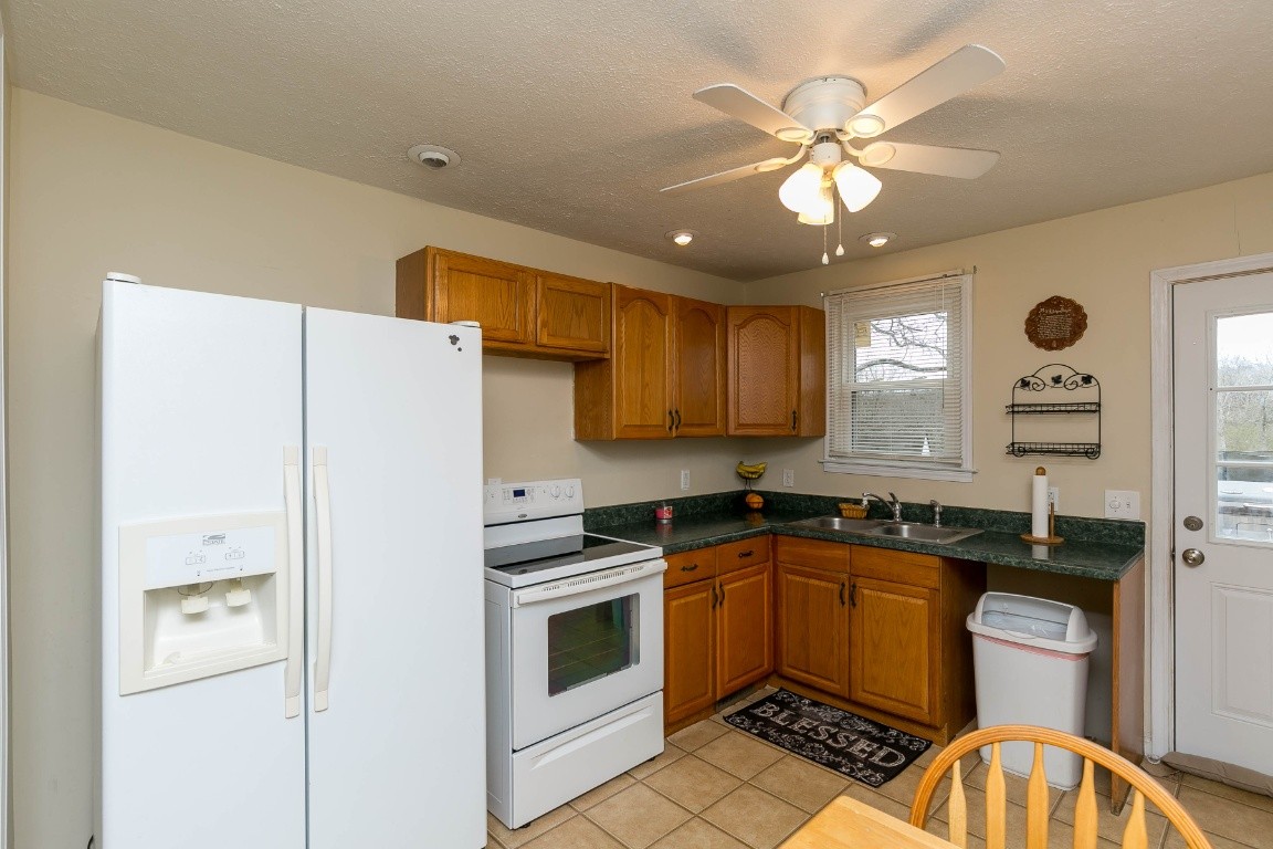 304 Randy Road Madison, TN 37115 - Photo 10 of 34 a kitchen with granite countertop a sink stainless steel appliances and cabinets
