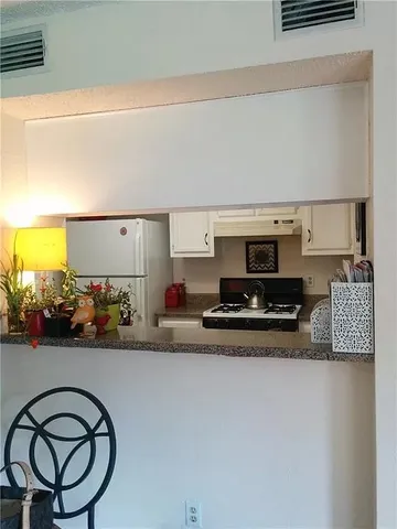 a kitchen with a stove a sink and a refrigerator