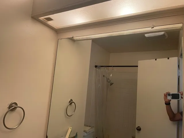 a bathroom with a shower and a sink