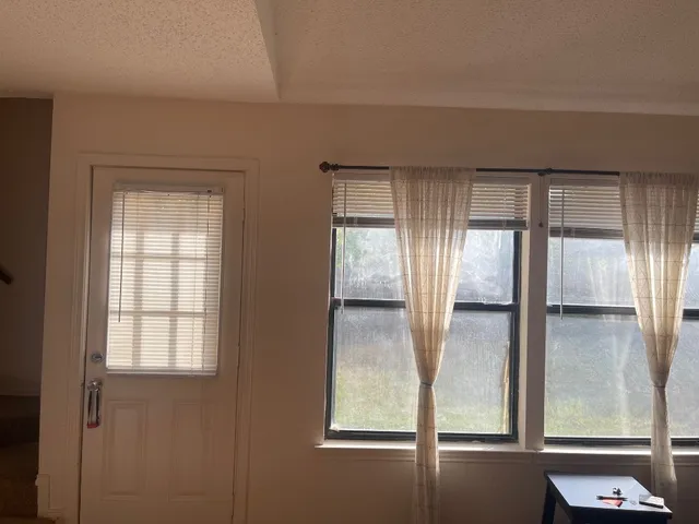 a view of an empty room and window